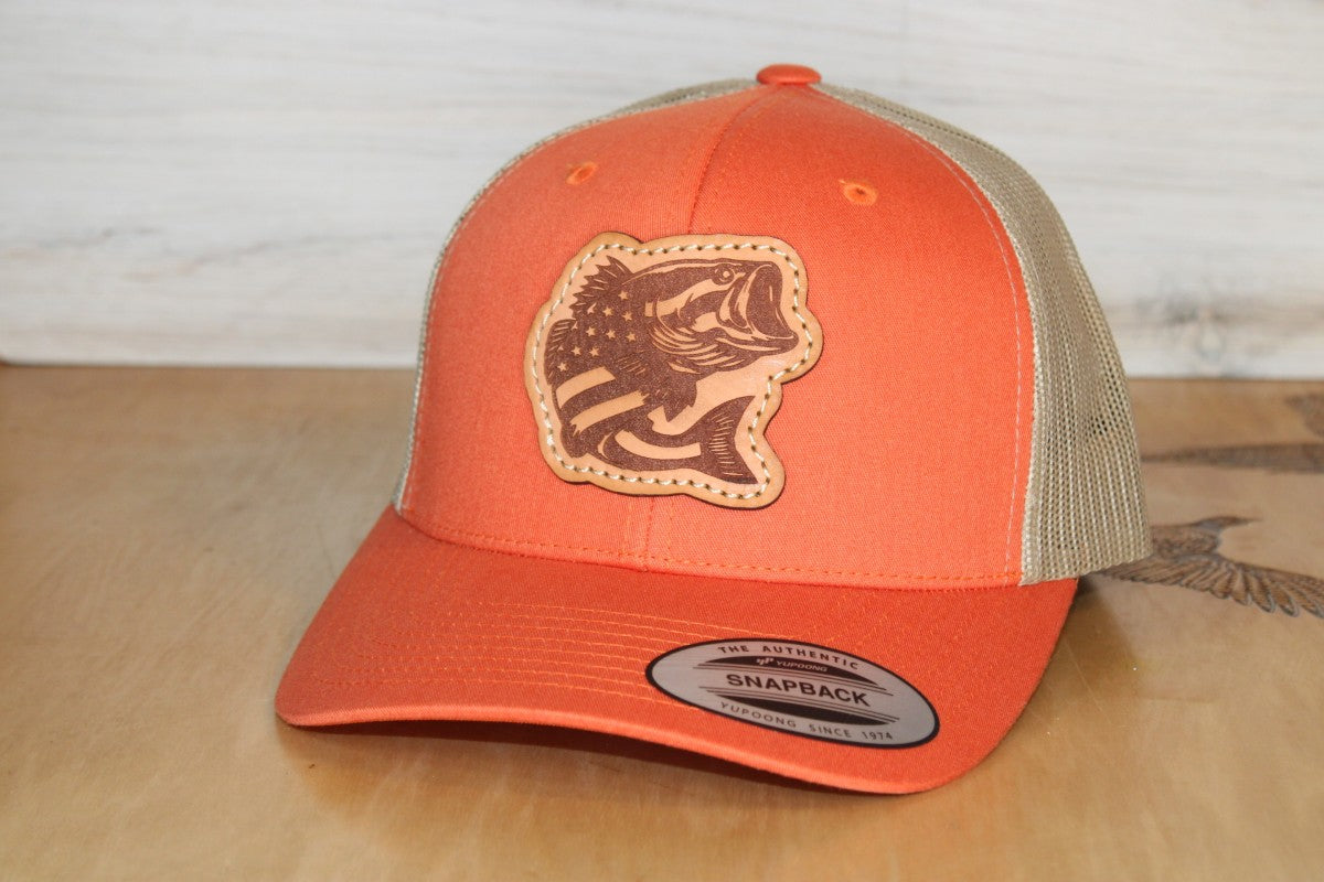 Orange and beige cap with a fishing leather patch