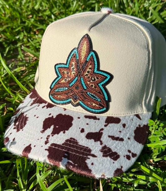 Cap with decorative emblem on a grass background