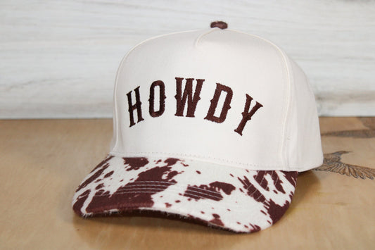 White cap with 'HOWDY' text and brown patterned brim