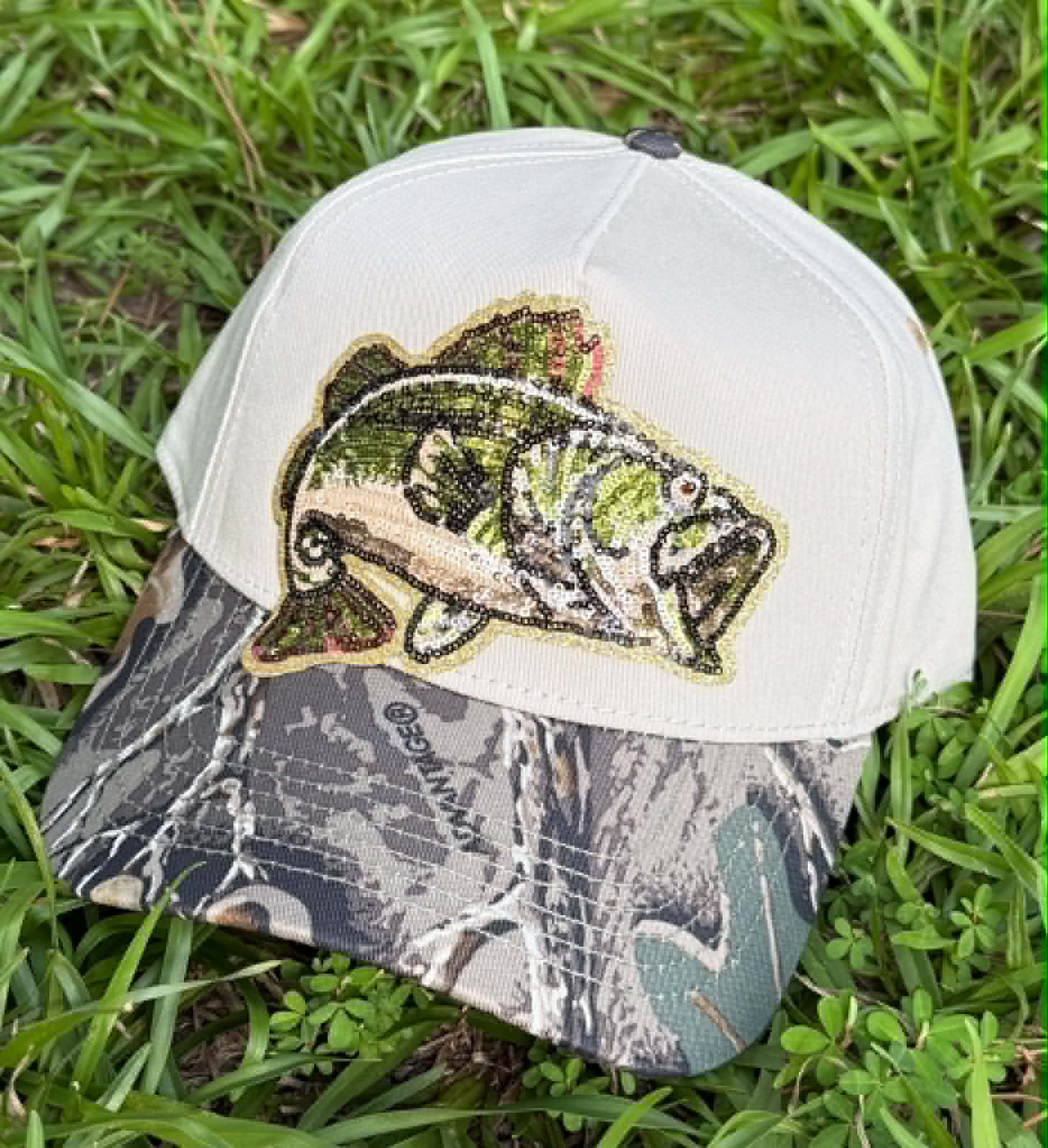 Cap with a fish design on a grass background