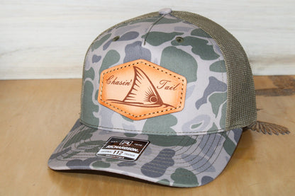 Camouflage-patterned marsh cap with redfish leather patch