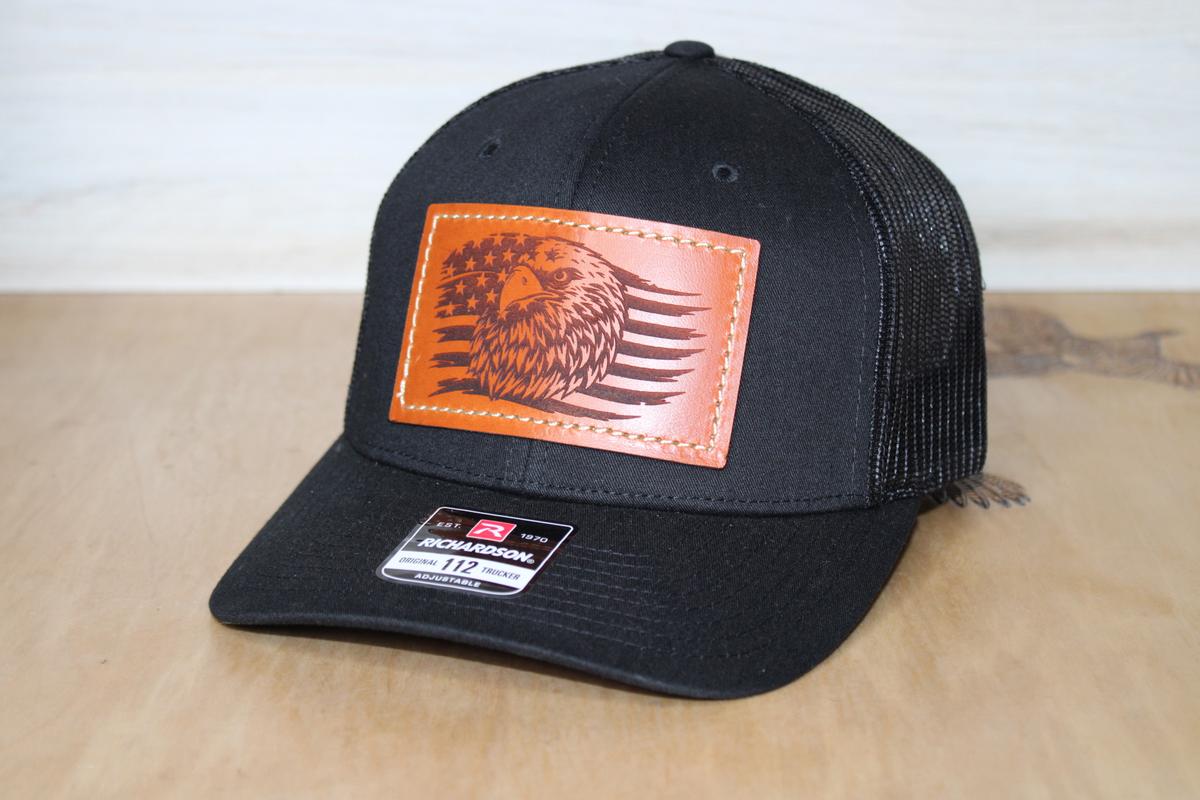 black hat with leather patch of eagle