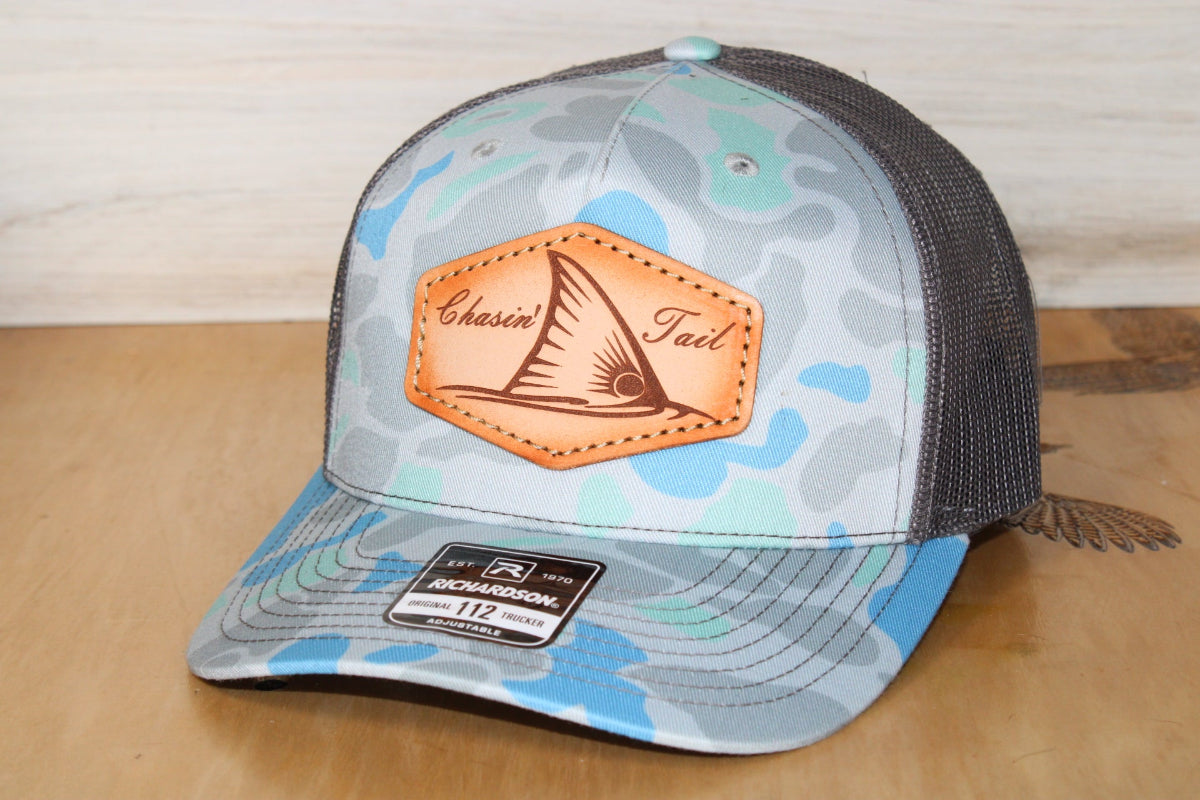 Camouflage-patterned cap with redfish leather patch